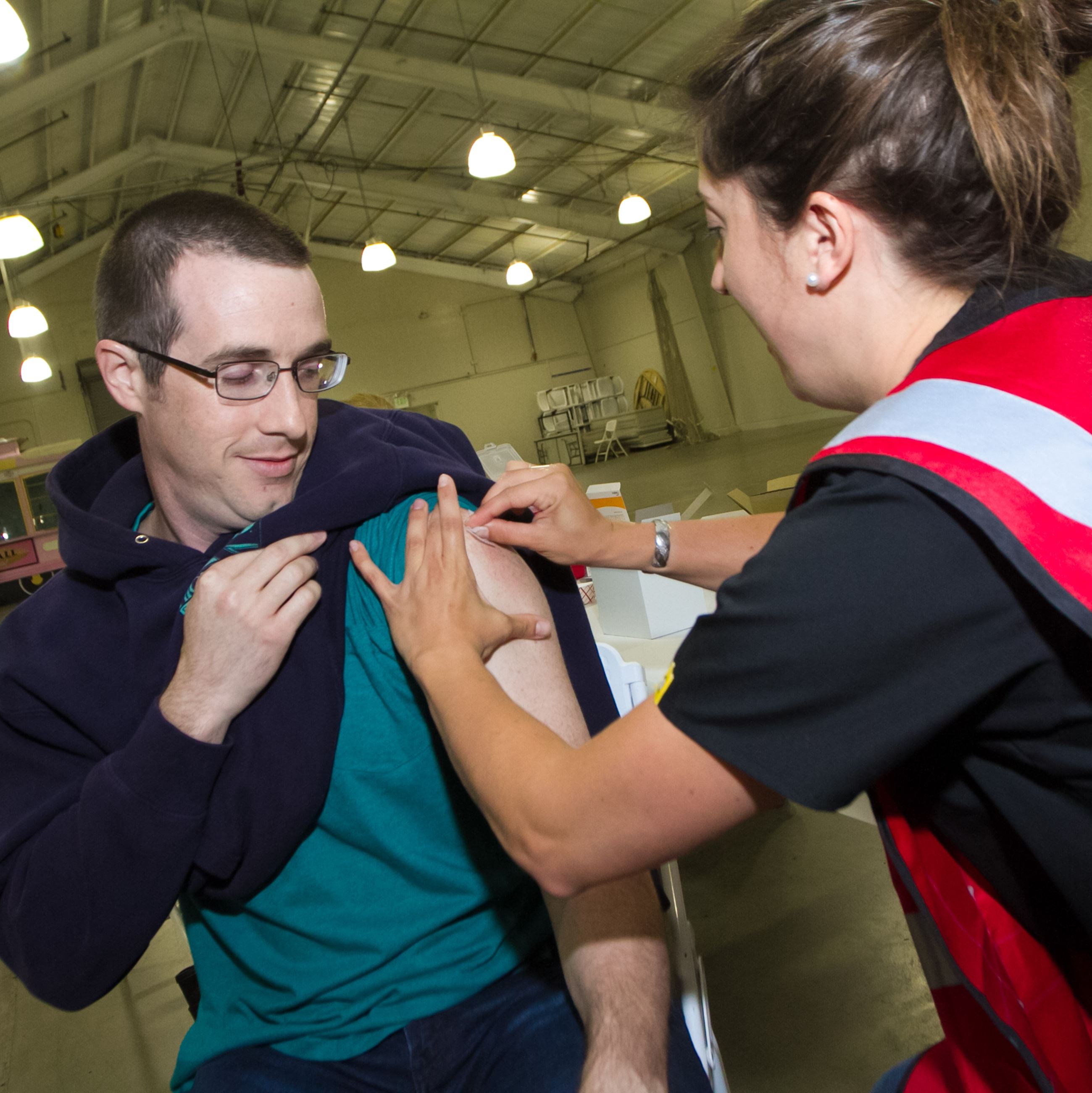 DHHS Senior Fiscal Assistant Jacob Michaud receives a vaccine.