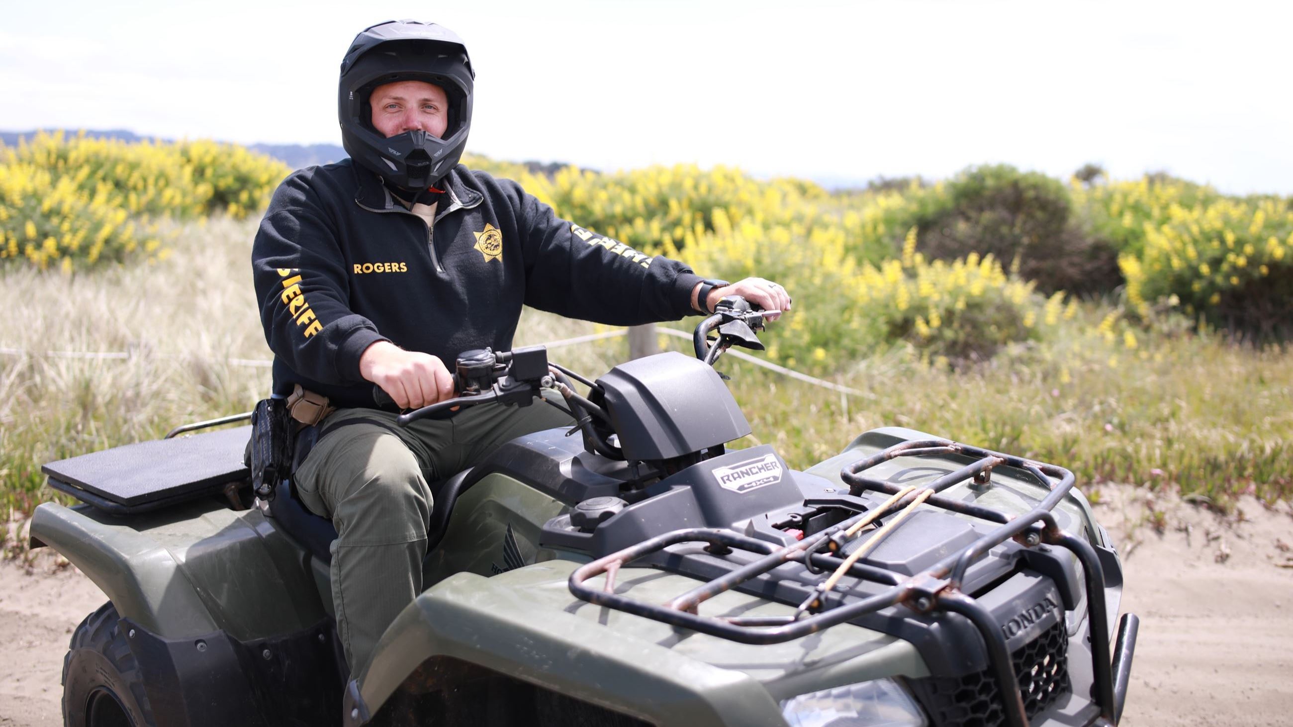 Sheriff's Deputy Travis Rogers sits on an ATV