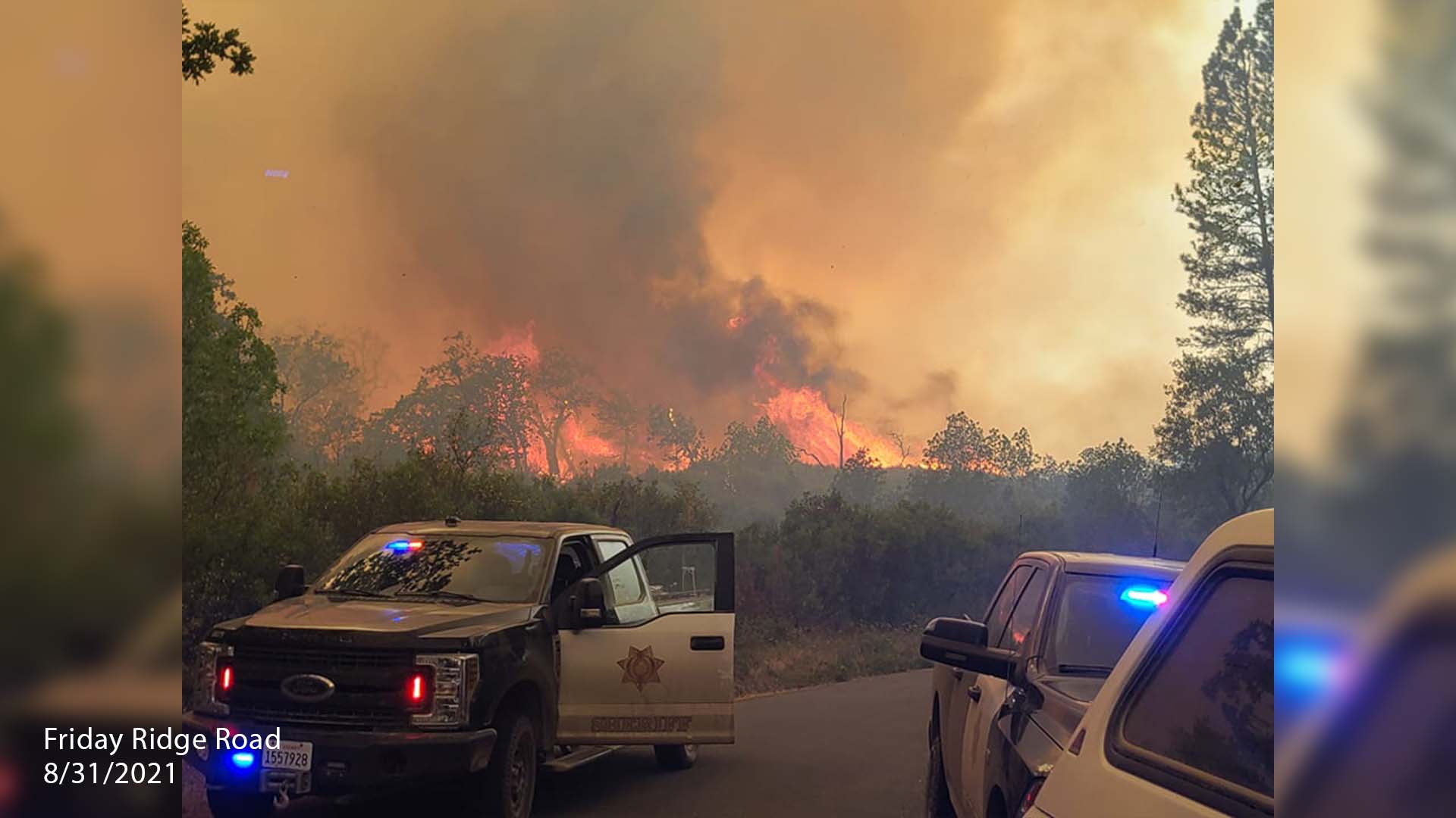 Patrol cars with Knob Fire in the background