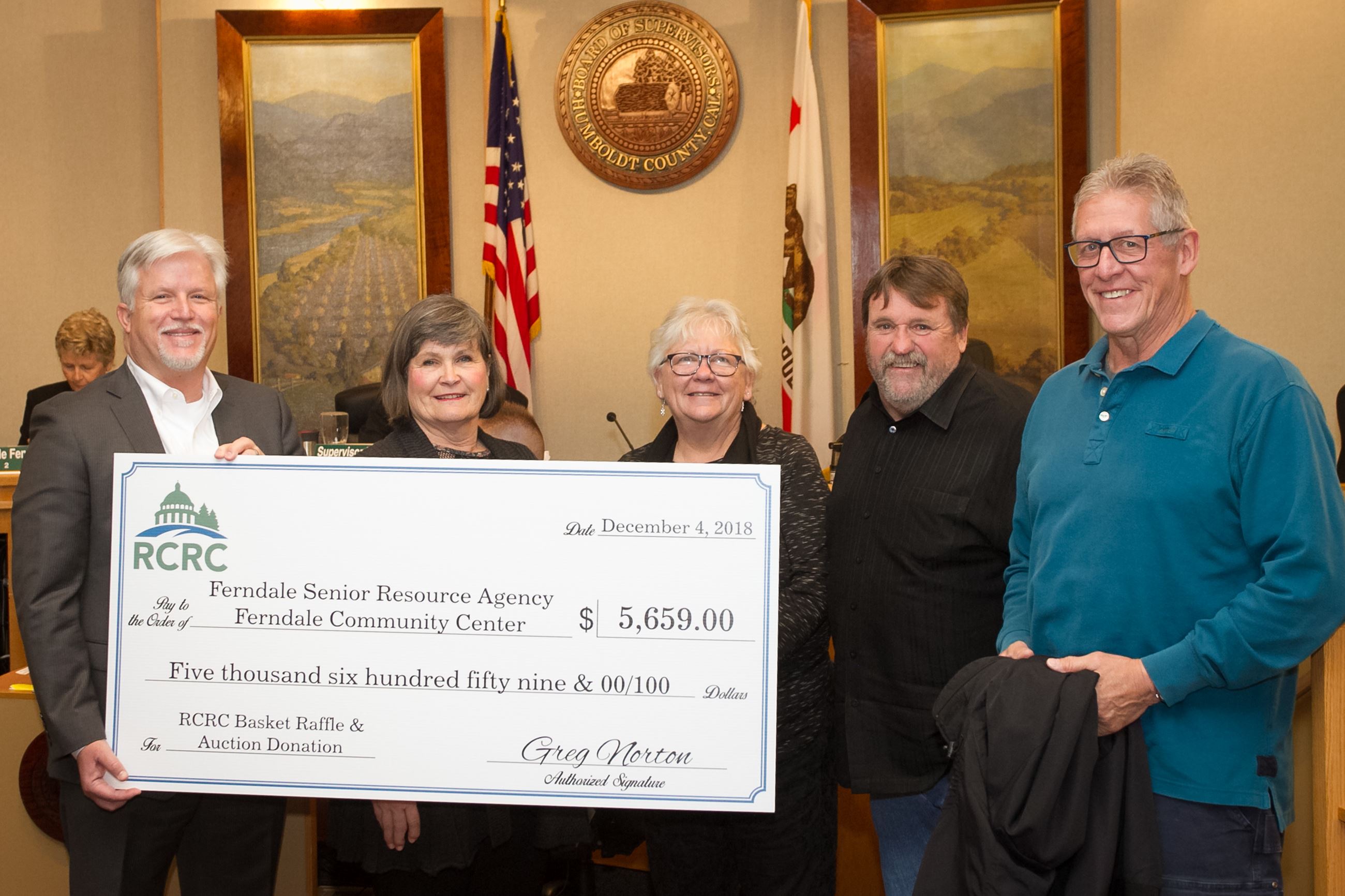 Supervisor Rex Bohn, second from right, and RCRC Chief Executive Officer Greg Norton, left, present 