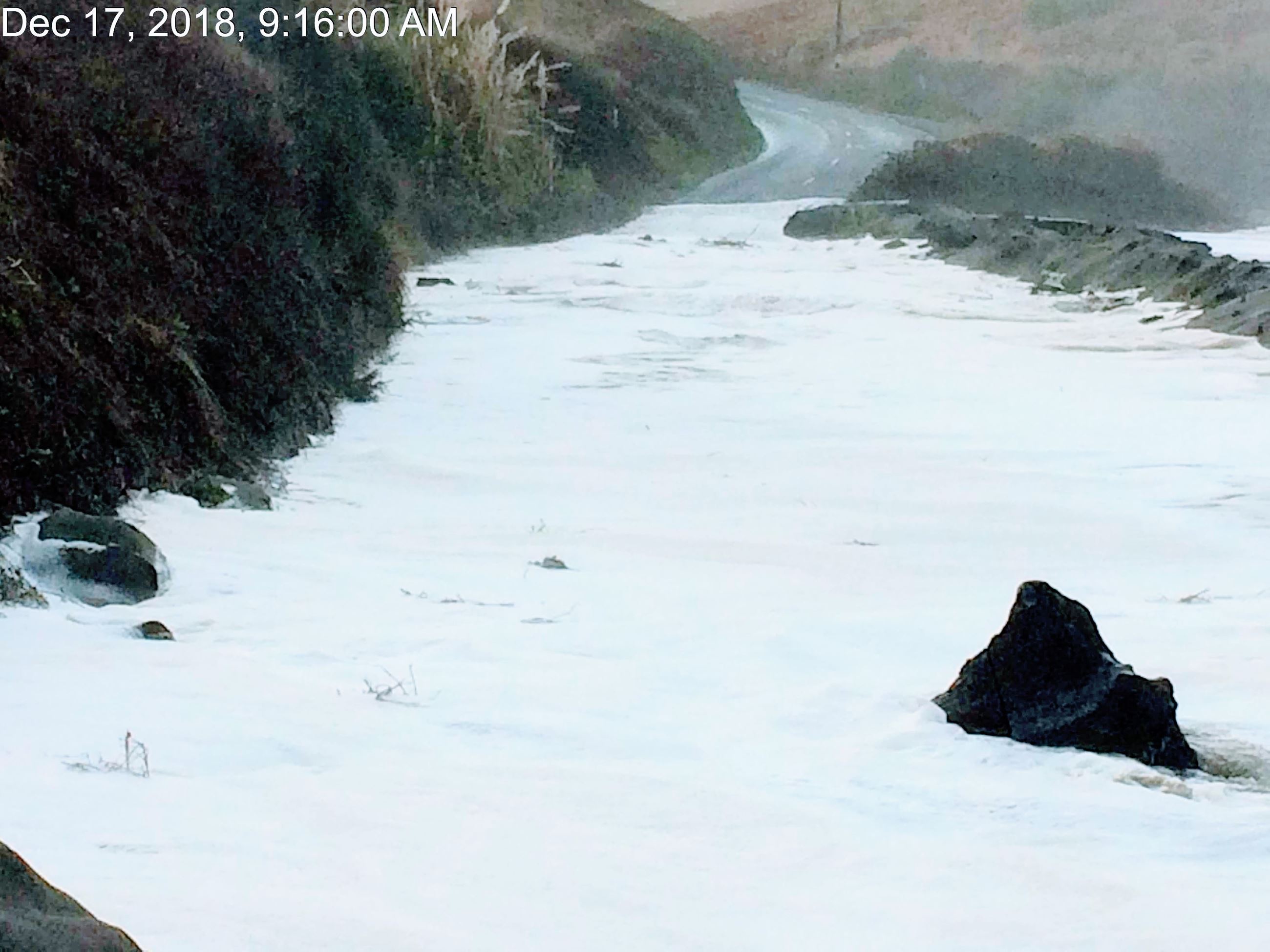 Waves crossing the roadway at Centerville Beach