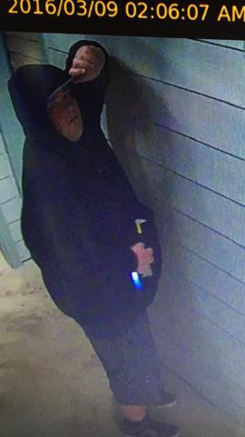 Suspect #1 wearing a dark hooded sweatshirt